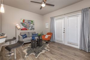 a living room filled with furniture and a window