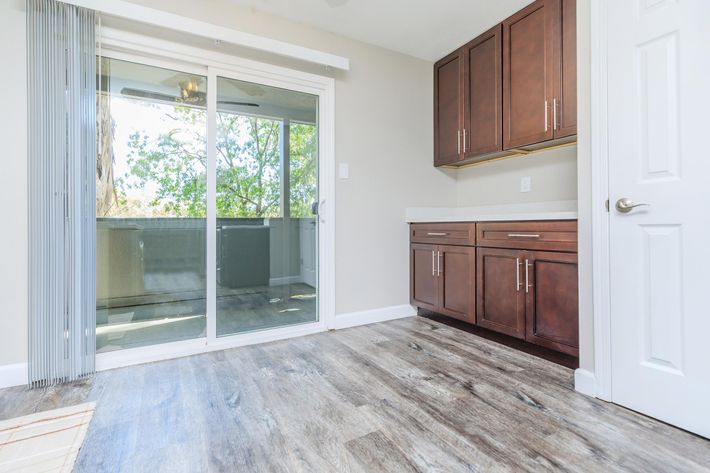 a kitchen with wooden cabinets and a window