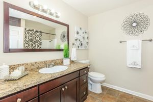 a kitchen with a sink and a mirror