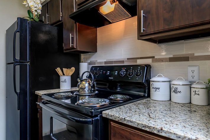 a stove top oven sitting inside of a kitchen