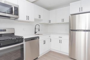 a stove top oven sitting inside of a kitchen