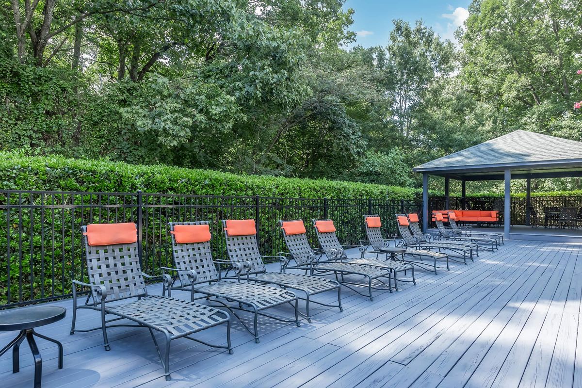 a group of lawn chairs sitting on top of a wooden fence