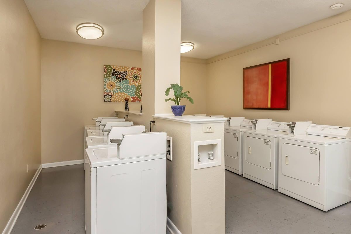 a room with a sink and a refrigerator