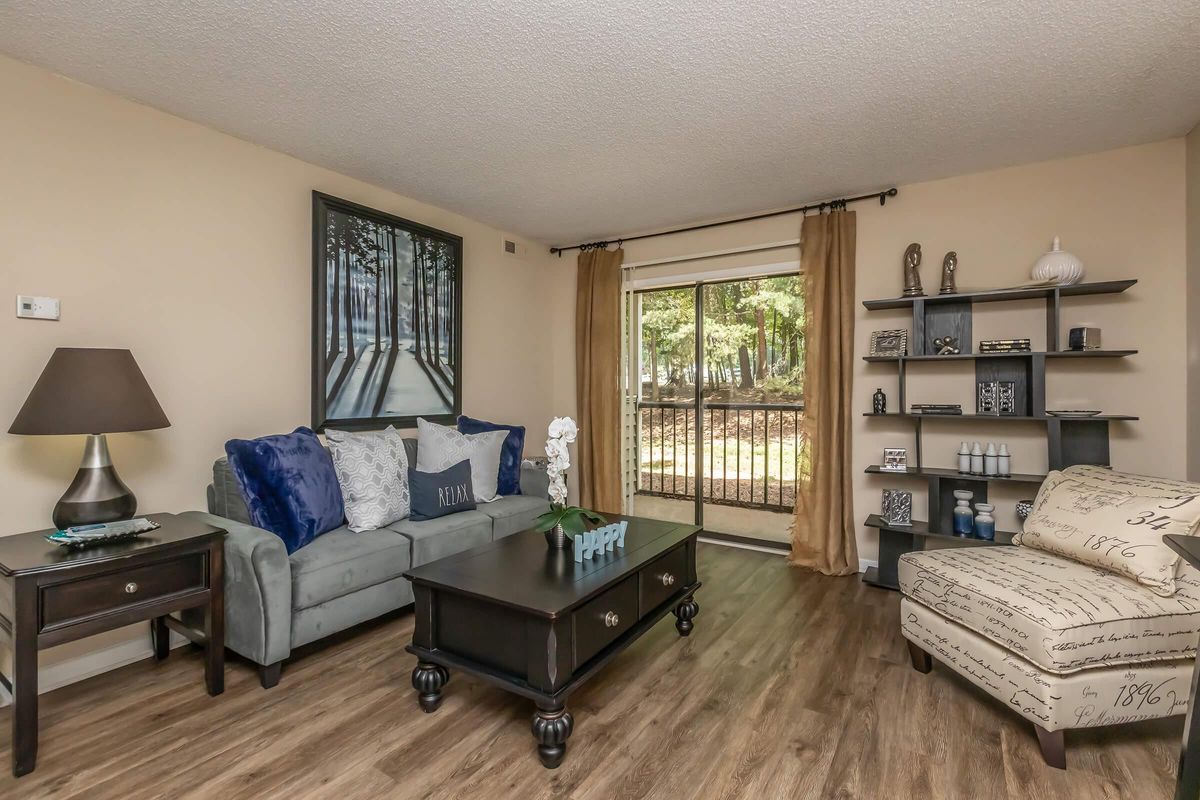 a living room filled with furniture and a flat screen tv