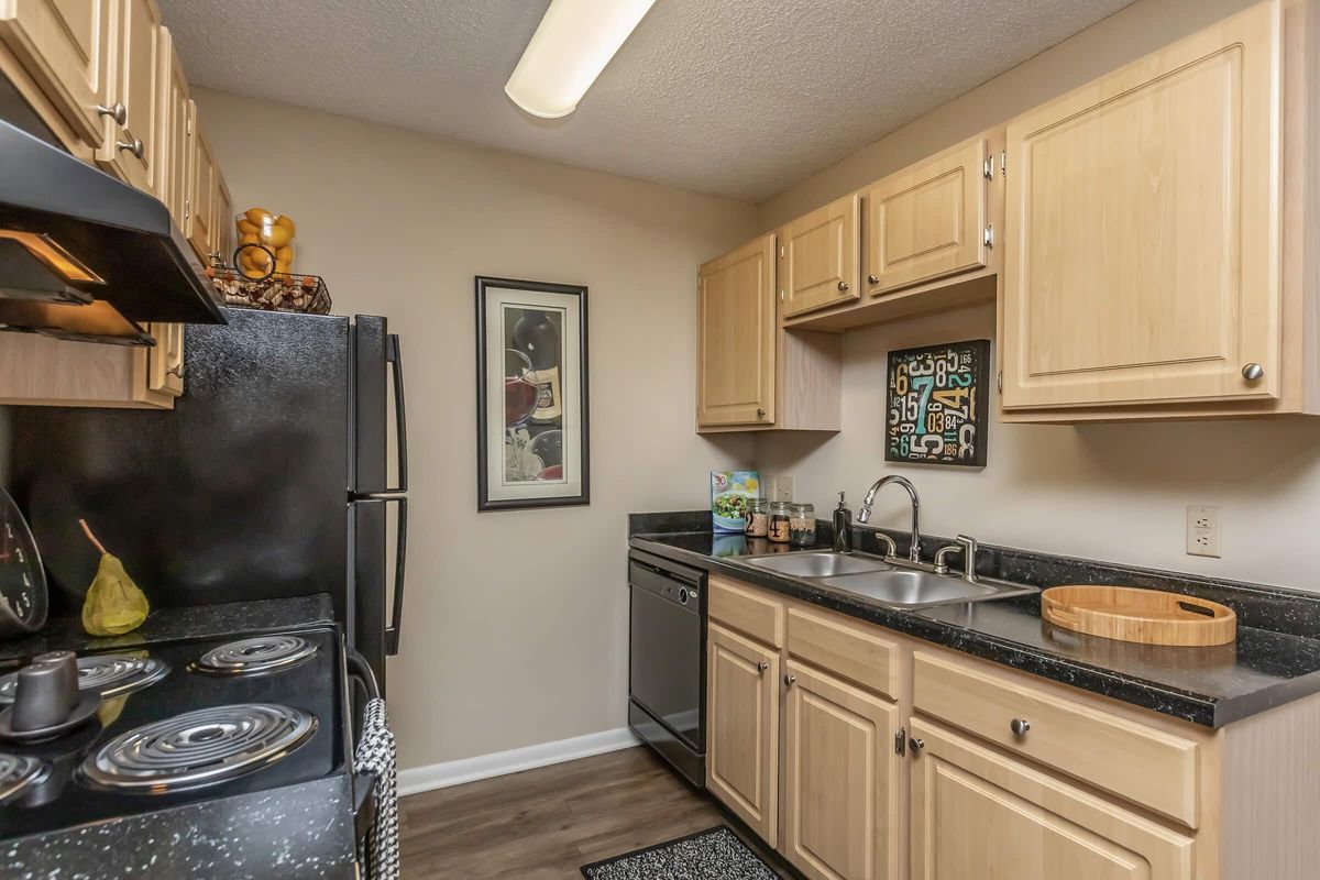 a kitchen with stainless steel appliances and wooden cabinets