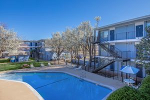 a house with a pool outside of a building