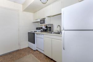 a kitchen with a stove and a refrigerator