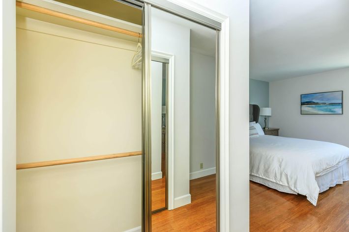 Bedroom closet with sliding mirror doors