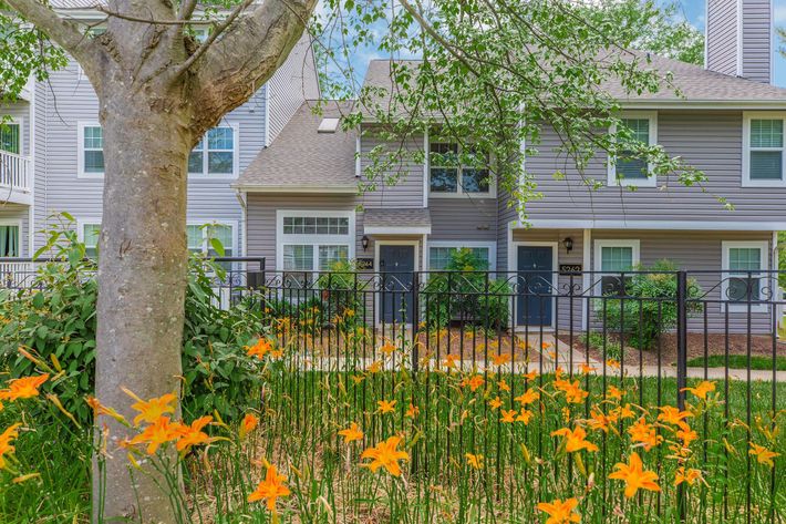 a colorful flower garden in front of a house