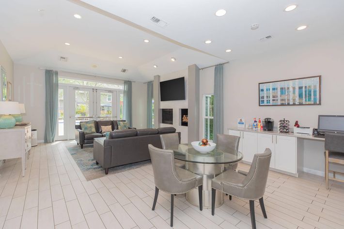 a living room filled with furniture and a large window