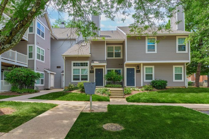 a house with a lawn in front of a building