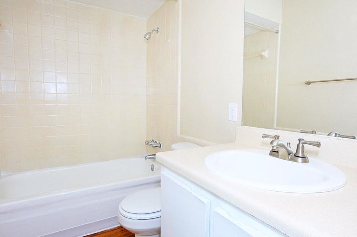 a white tub sitting next to a sink
