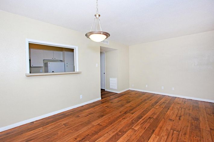 a large empty room with a wooden floor