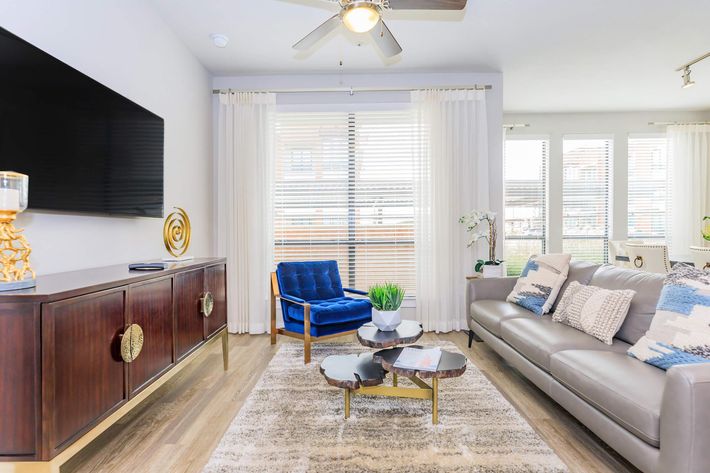 a living room filled with furniture and a large window