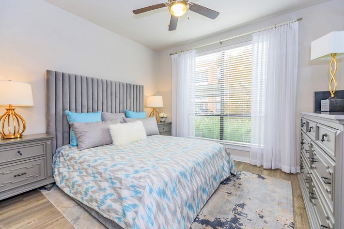 a bedroom with a bed and desk in a room