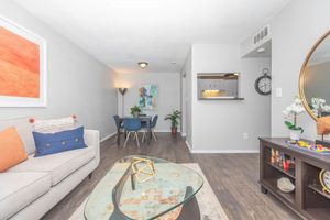 a living room filled with furniture and a flat screen tv