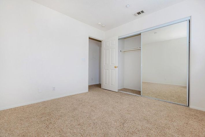 Bedroom with sliding glass mirror closet doors