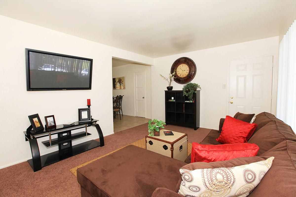 a living room filled with furniture and a flat screen tv