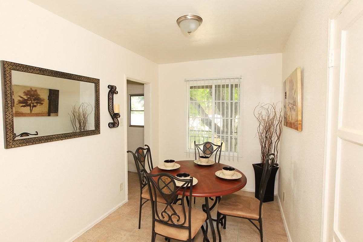 a dining room table in front of a mirror