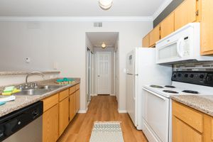 unfurnished kitchen with white appliances