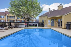 a house with a pool in front of a building