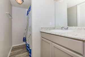 a kitchen with a sink and a mirror