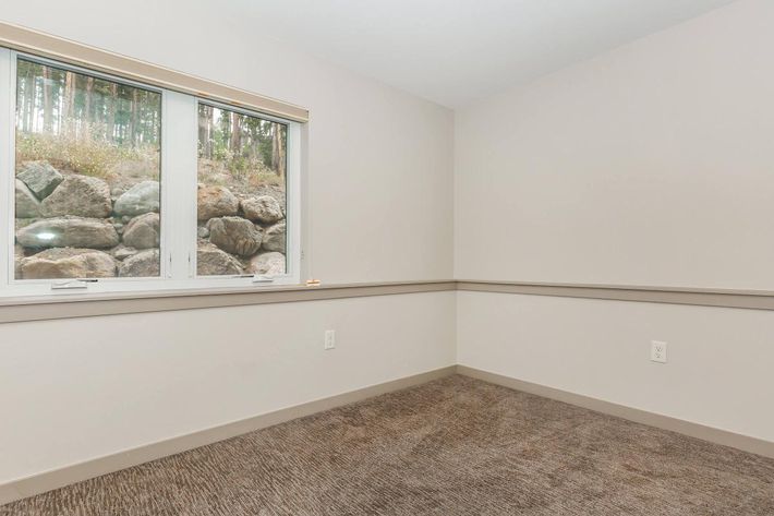 a bedroom with a large window