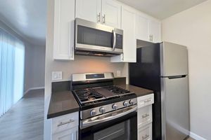 a stove top oven sitting inside of a kitchen