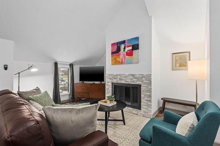 a living room filled with furniture and a tv