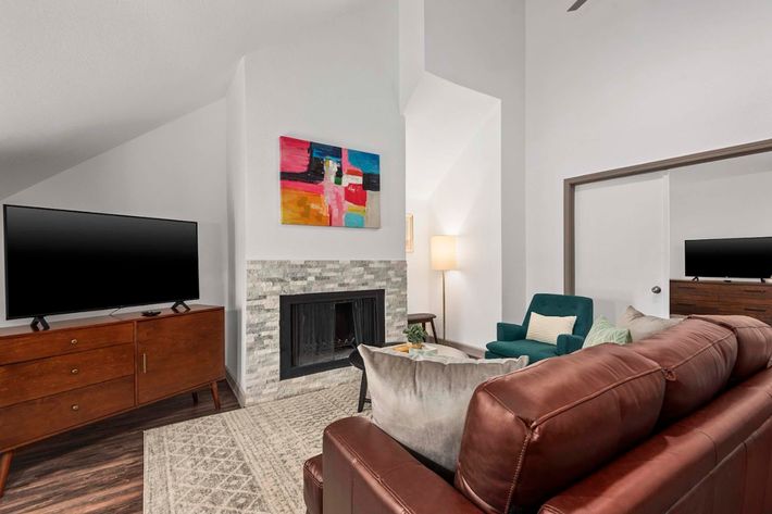 a living room filled with furniture and a flat screen tv