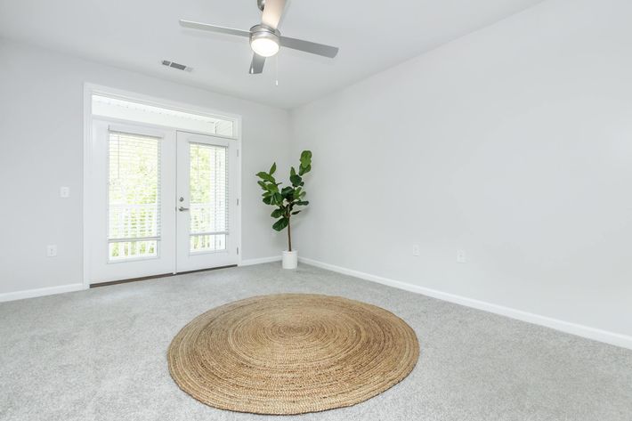 a room filled with furniture and vase of flowers