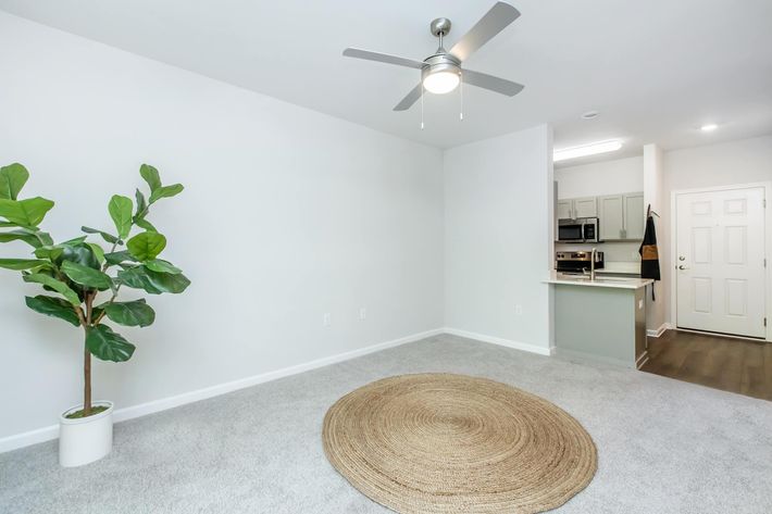 a room filled with furniture and vase of flowers on a table