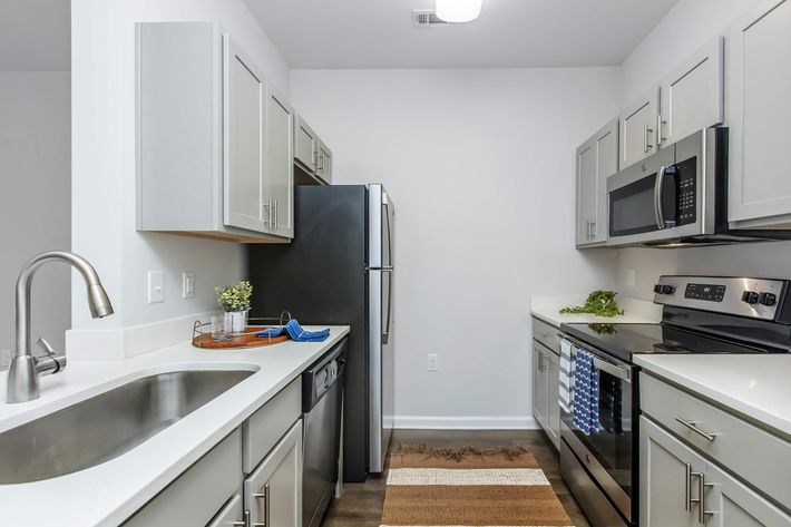 a kitchen with a stove a sink and a microwave