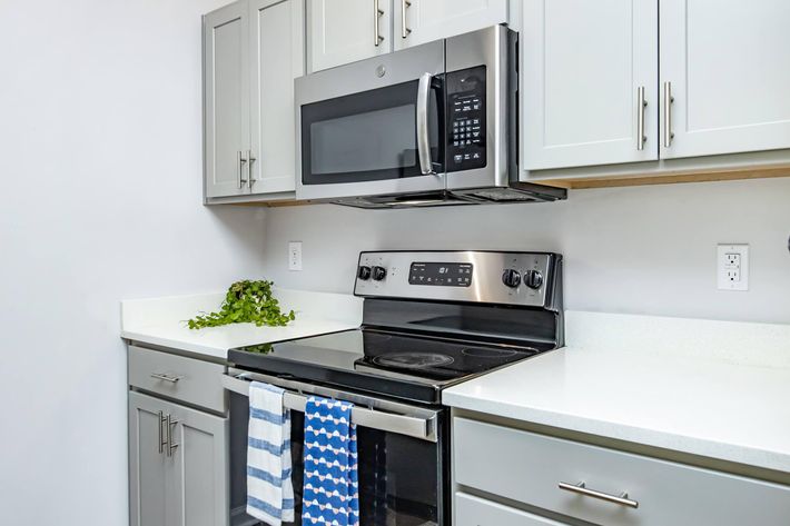 a stove top oven sitting inside of a kitchen