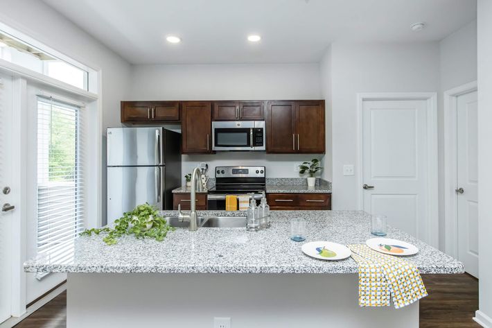 a modern kitchen with an island in the middle of a room