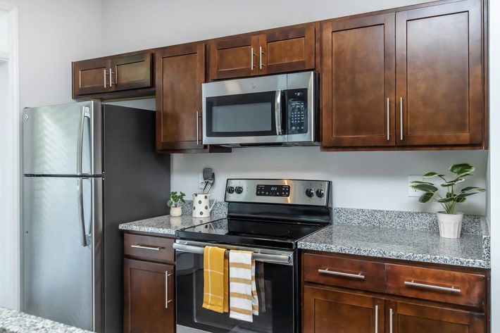 a kitchen with stainless steel appliances and wooden cabinets