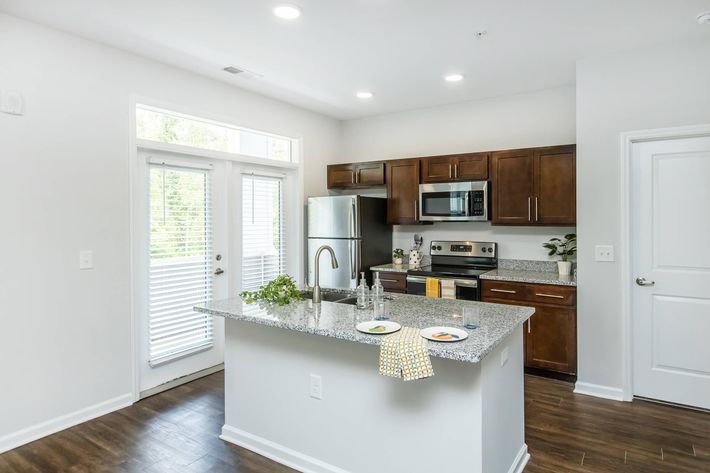 a kitchen with an island in the middle of a room