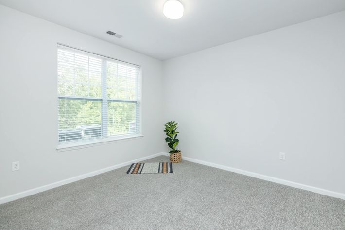 a bedroom with a large window