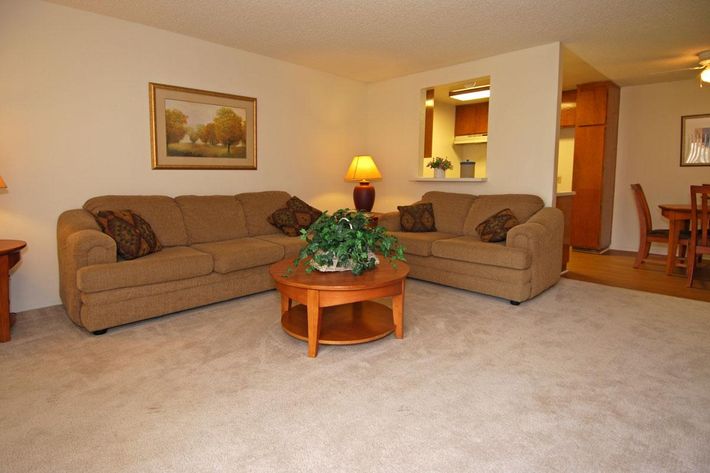 a living room filled with furniture and a flat screen tv