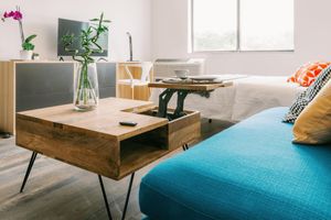 a living room filled with furniture and vase of flowers on a table