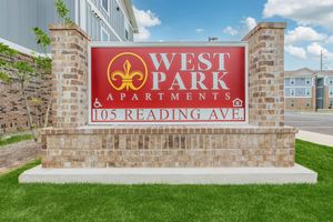 a sign in front of a brick building