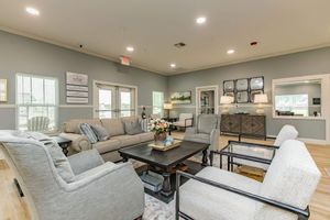 a living room filled with furniture and a large window