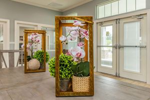 a room filled with furniture and vase of flowers