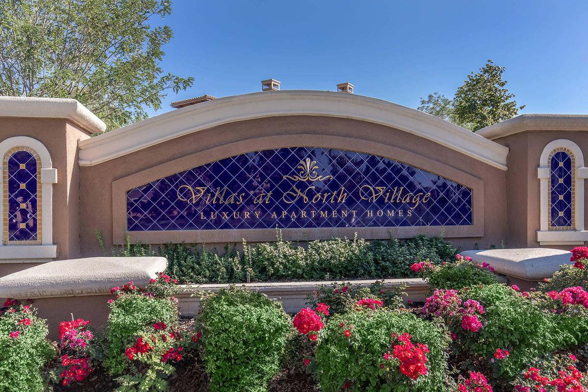 a close up of a flower garden in front of a building