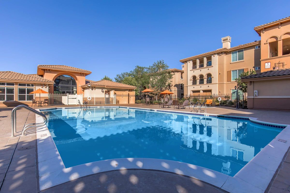 a blue pool of water in front of a building