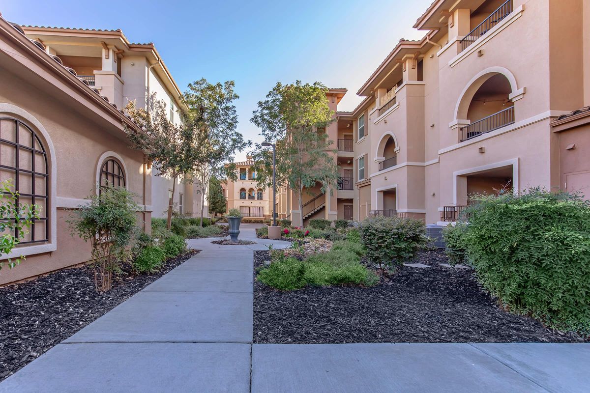 a garden in front of a brick building