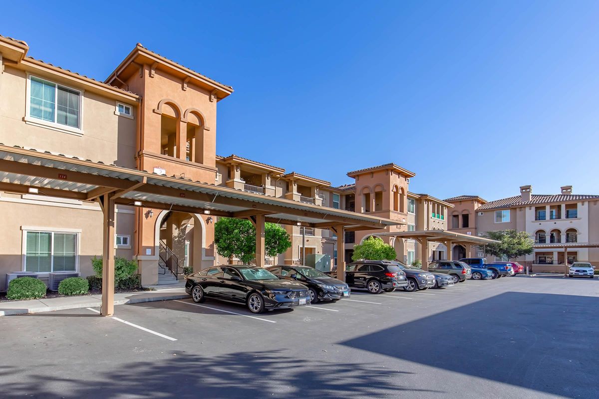 a street with cars parked on the side of a building