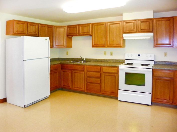 a kitchen with a stove and a refrigerator