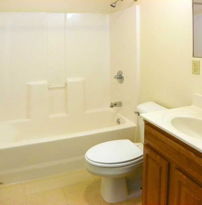 a large white tub sitting next to a sink