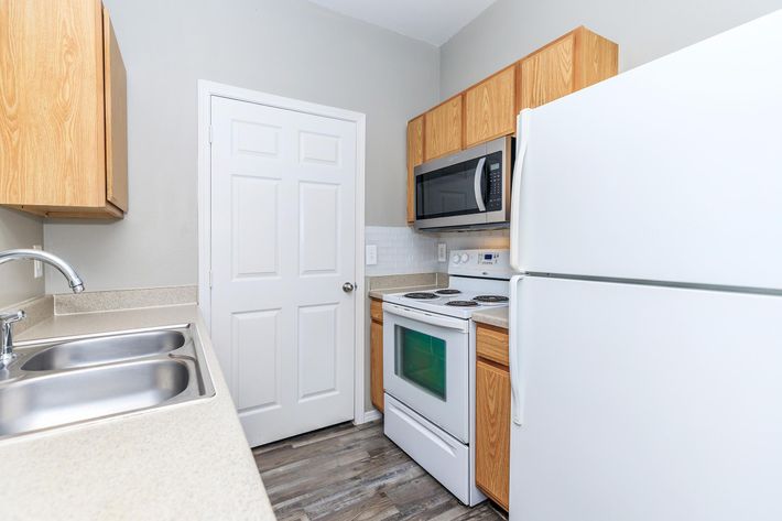 a kitchen with a stove top oven sitting inside of a refrigerator